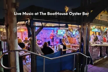 Outdoor bar with live music and seated patrons at night.